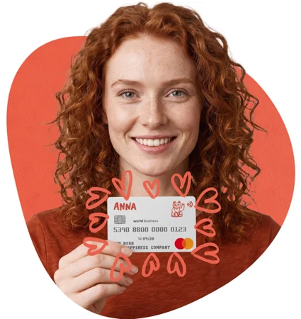 Smiling business owner holding their ANNA business Mastercard, framed by hand-drawn heart doodles